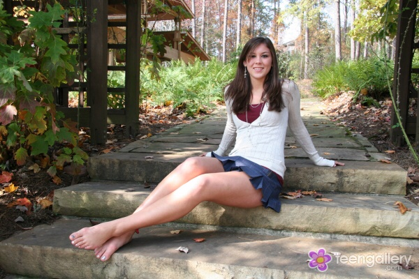 Classy brunette with long legs and bare feet
