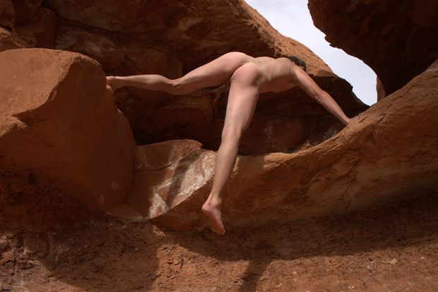 nude male climbing in desert display strong ass back and legs