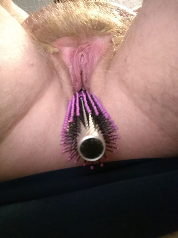 Pussy clothespinned open, hairbrush handle stuffed in