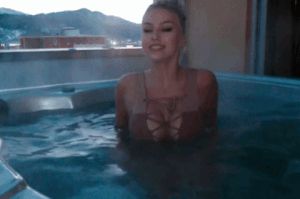 Sexy babe exposes bare breasts in hottub