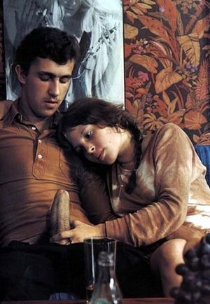 Youthful milf carefully studies the cock and jerks it gently