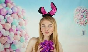 Cute blonde holding a pom pom covering her chest