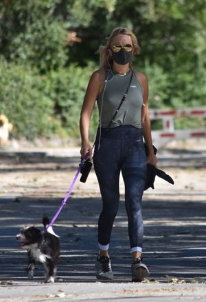 Malin Akerman braless boobs in a tank top showing off her big tits pokies seen by paparazzi while out walking her dog.