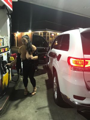 Busty woman at the gas pumps