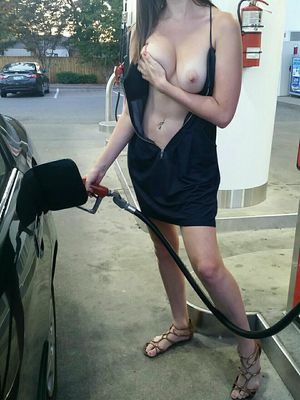 Woman flashing tits while pumping gas