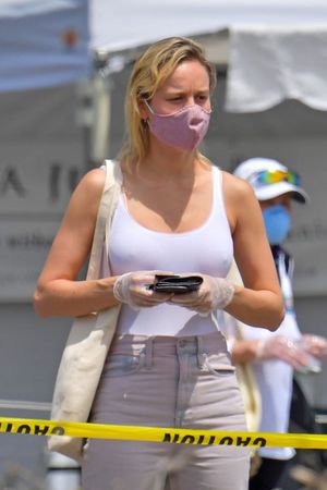 Brie Larson boobs in a white tank top and even with a bra showing her hard nipple pokies seen by paparazzi at a farmers market.