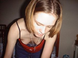 Candid downblouse shot of some tiny funbags as a cutie is focused on her chores.