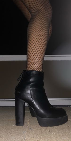 Fishnet pantyhose with a leather skirt and super high heels