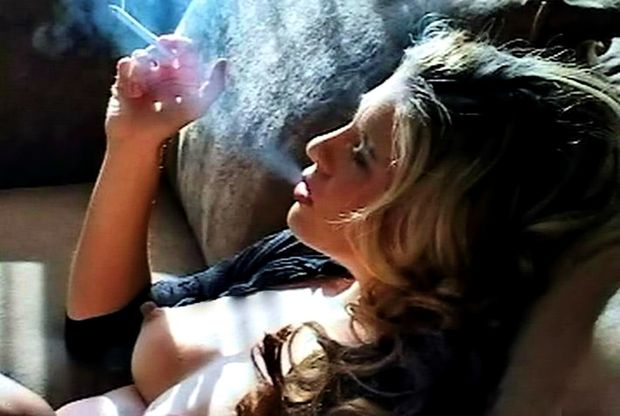 Mature woman relaxing having a smoke,....very nice tits!