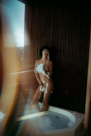 Lively blonde, has fun taking a bubble bath