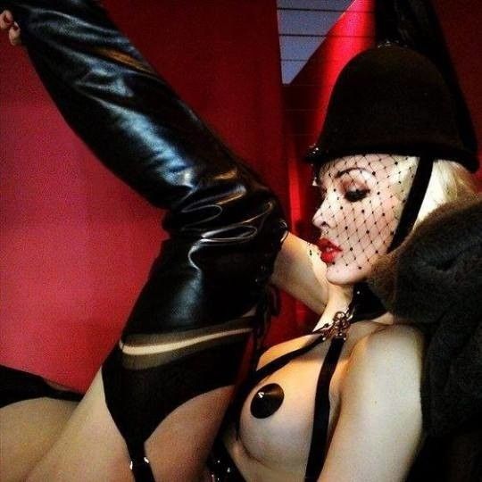 Blonde fetish Mistress in riding helmet, stockings and boots