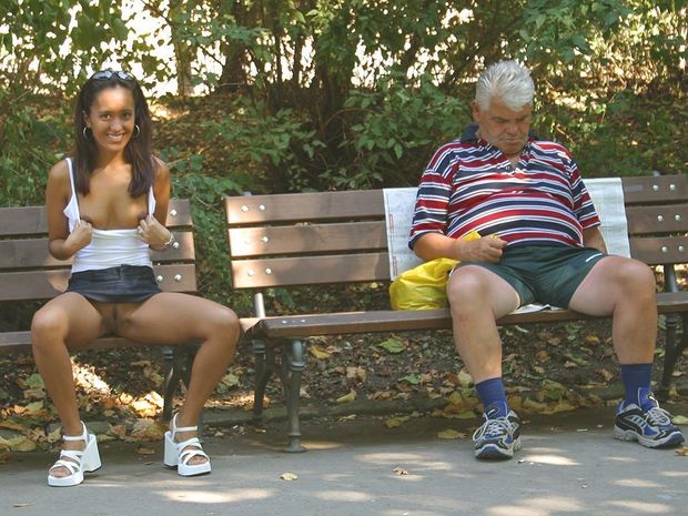 Naughty showing my naked pussy next to a sleeping man on a park bench