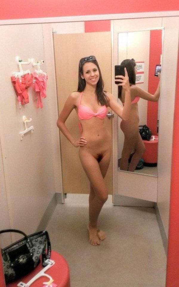 Cute girlfriend taking a nude selfie while shopping- See more sexy girlfriends on our blog