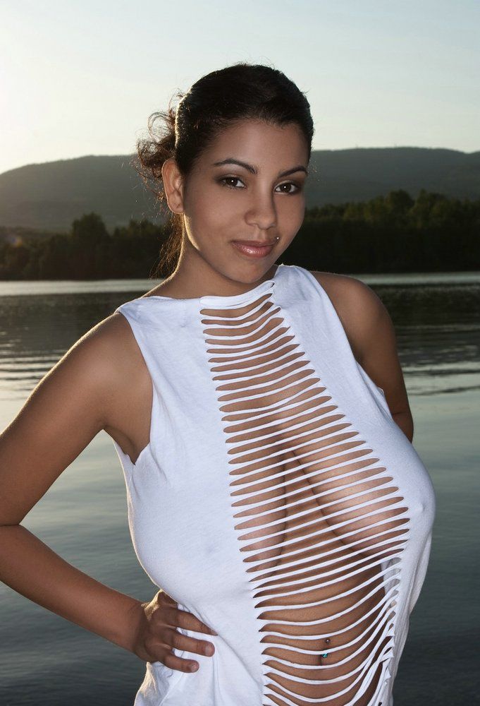 Insane pair of massive gorgeous hangers barely concealed in a shredded blouse. What a great look.
