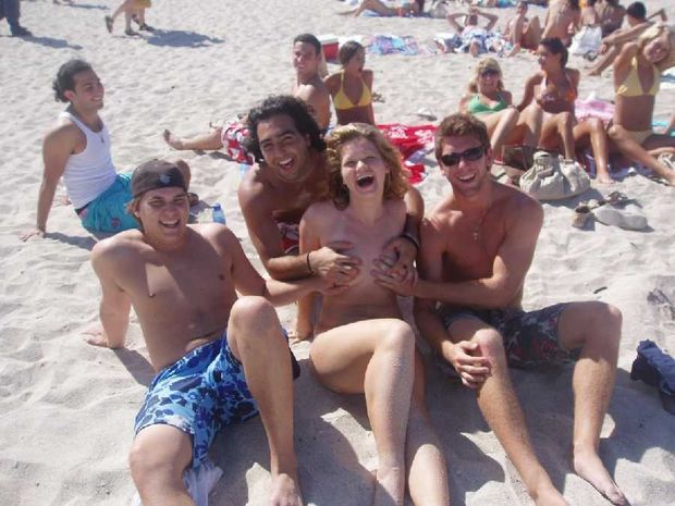 Three friends grope her boobs on the beach.