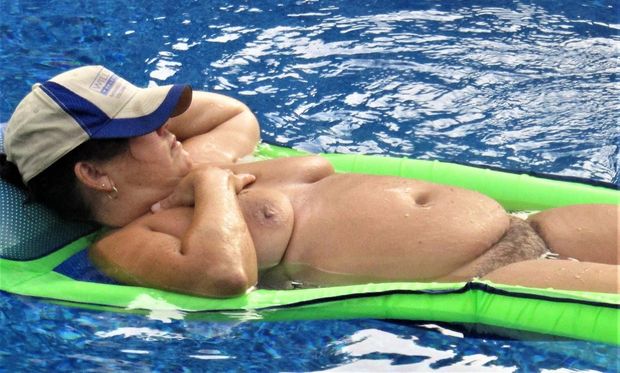 The neighborhood whore undressing at the pool.