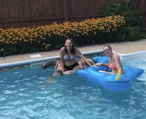 Two teens on pool floats