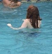 Teen floating in the pool