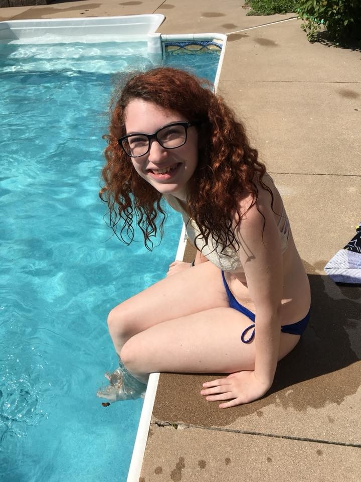 Teen sitting on the edge of the pool