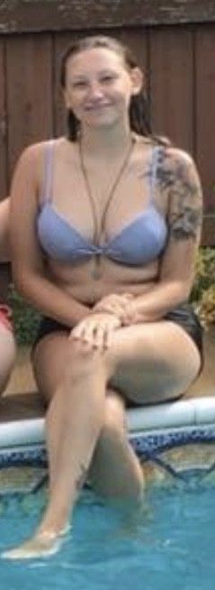 Teen sitting on the edge of the pool with her legs crossed