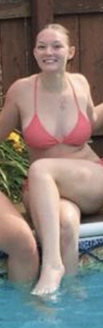 Teen sitting on the edge of the pool with her legs crossed