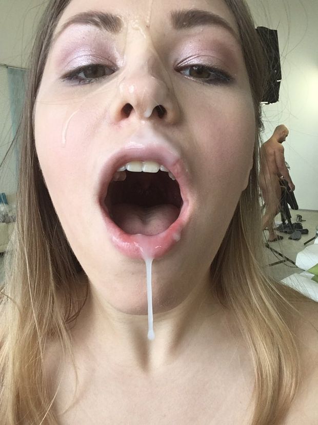 Cute chick gets her face covered in cum