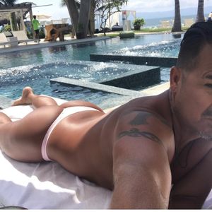Sexy man tanning in thong