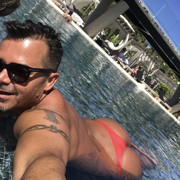 Sexy man tanning in thong