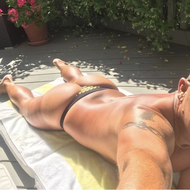 Sexy man in thong tanning ass