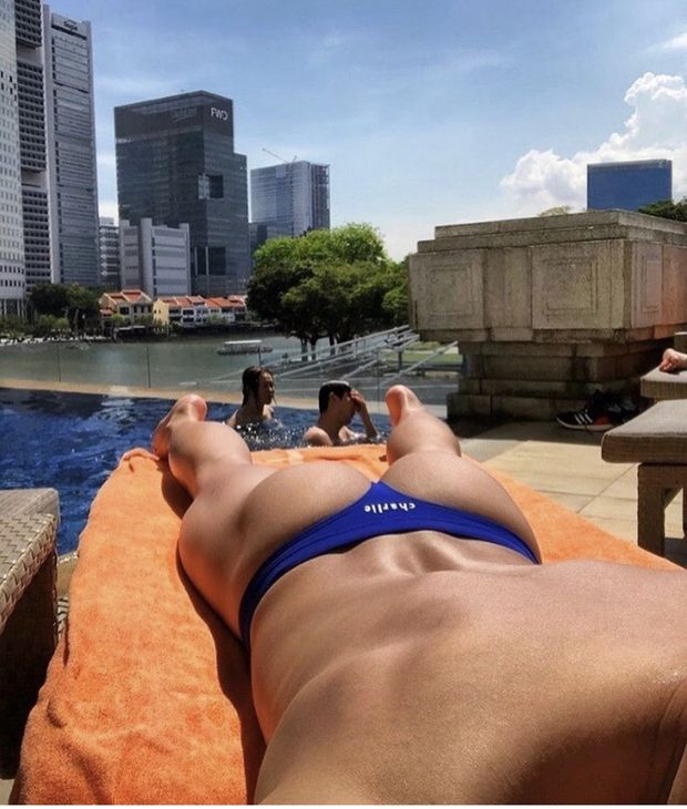 Hot ass man laying out by pool in thong bikini