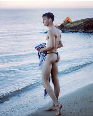 Guy at the beach wearing a thong