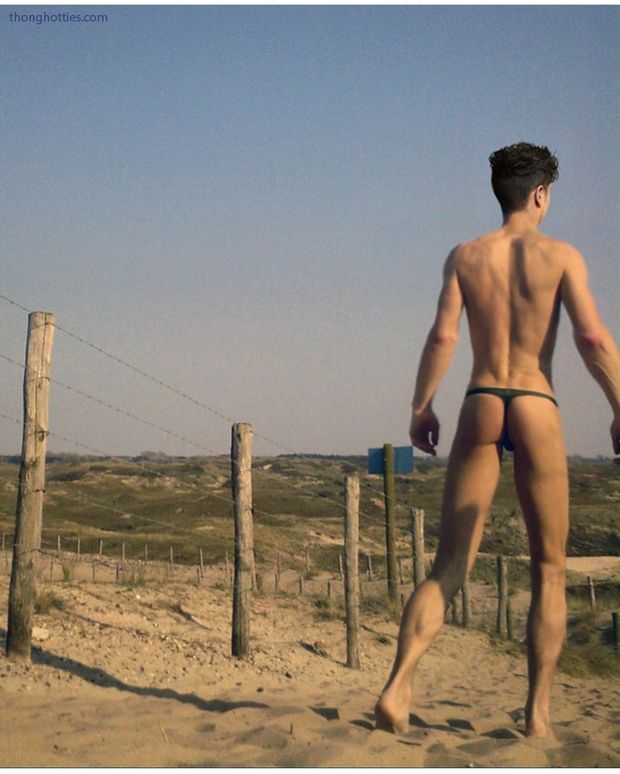 Gay guy at beach in thong bikini