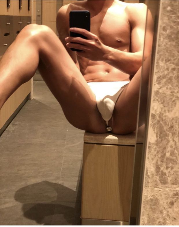 Gay guy with butt plug and thong in locker room