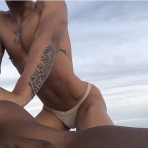 Sexy guy at the beach in thong bikini