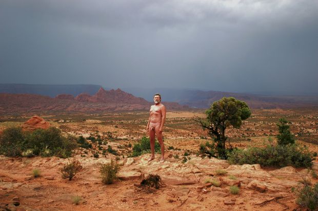 nude male in desert rain storm