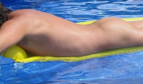 male sunbathing in a pool