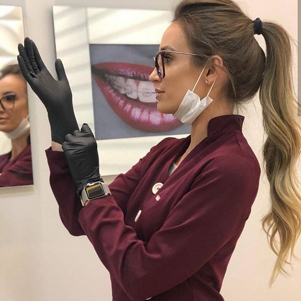 Sexy doctor putting on gloves