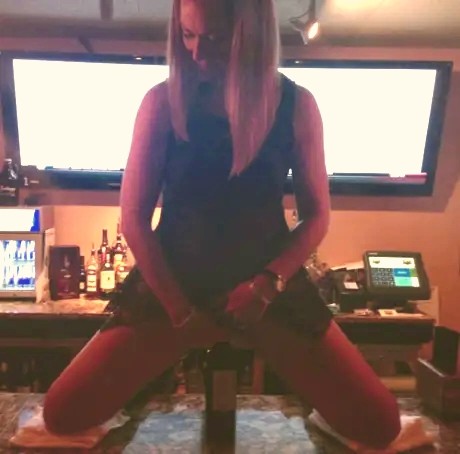The barmaid had an interesting way of opening a bottle.
