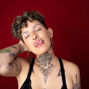 Tattooed woman with a split tongue