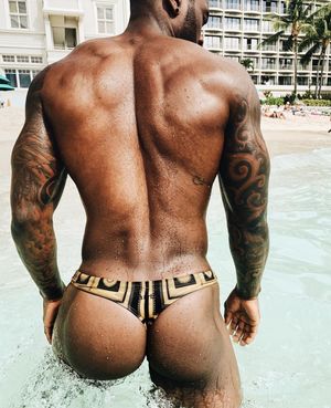 Sexy gay guy in thong by the pool