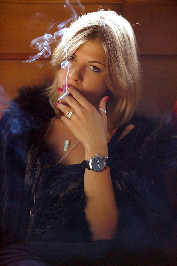 Sexy woman in furs smoking