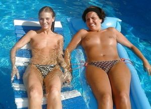 Mom and daughter topless sunbathing