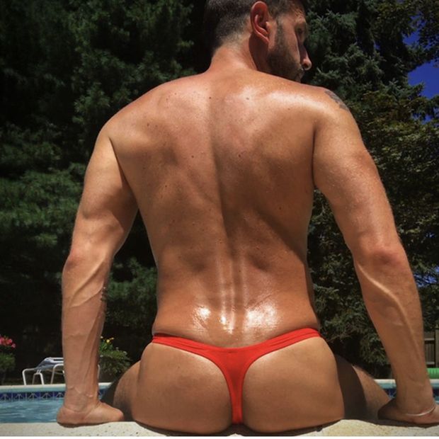 Fit ass guy in thong by the pool