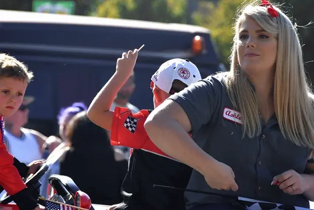 Cute blonde handing out candy in parade