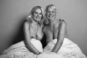Topless mom and daughter in bed