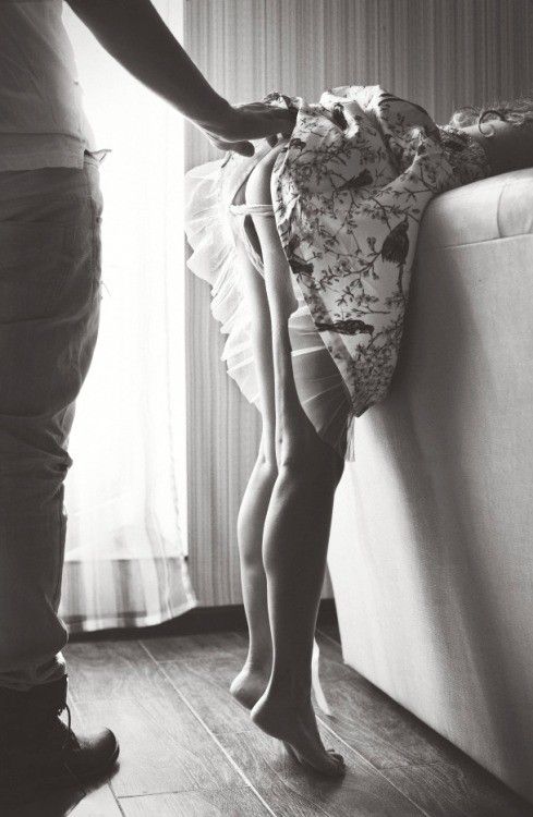Bending over the couch, getting ready on her tippy-toes