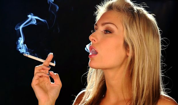 Sexy blonde woman french inhaling her cigarette smoke.