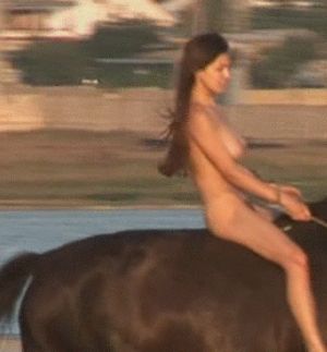 Naked babe riding a horse