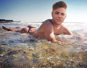 Sexy teen guy in thong at beach