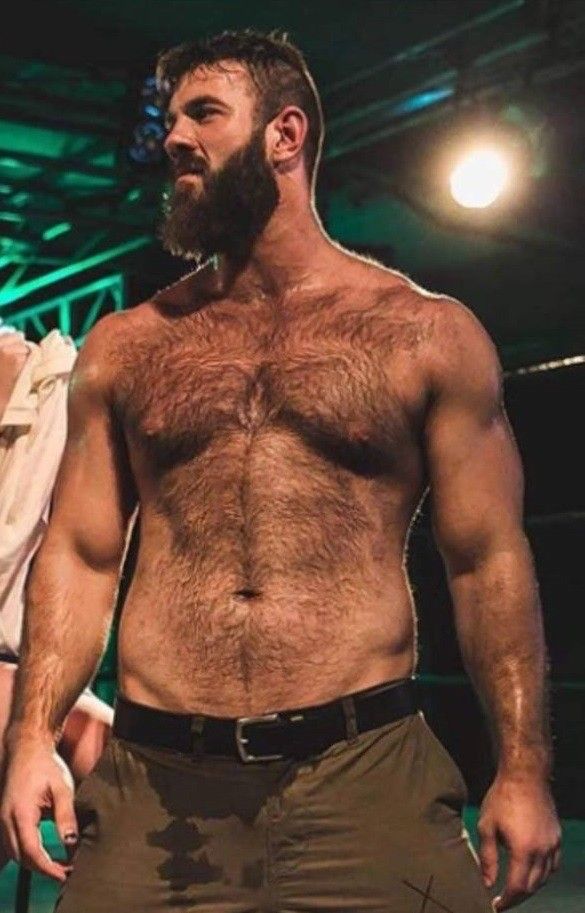 Hairy stud poses shirtless in camo shorts
